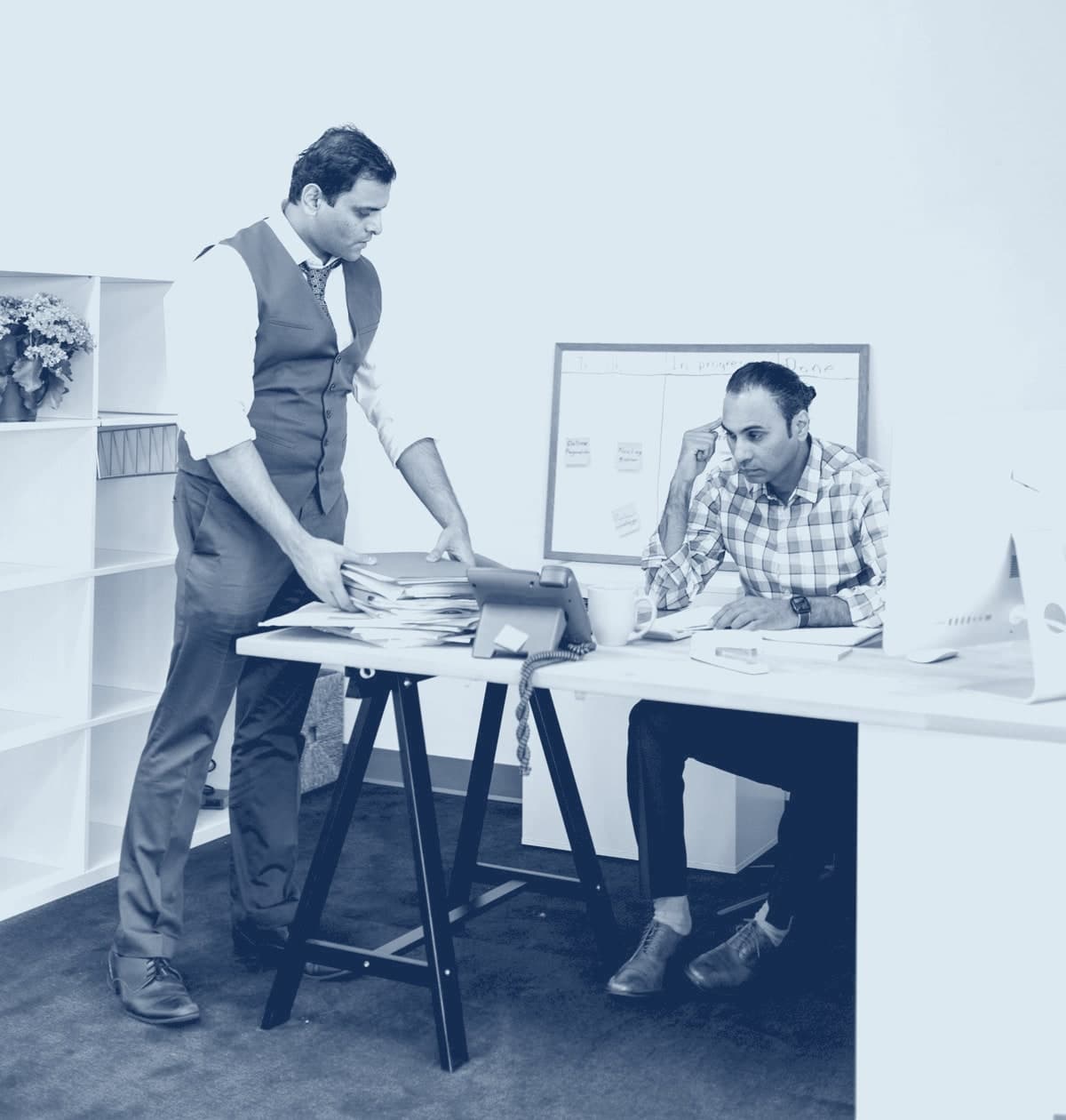 Two colleagues reviewing a shortlist at a desk